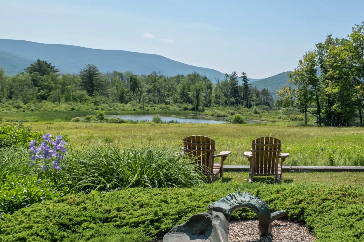 Adirondack chairs in the garden with mountain views