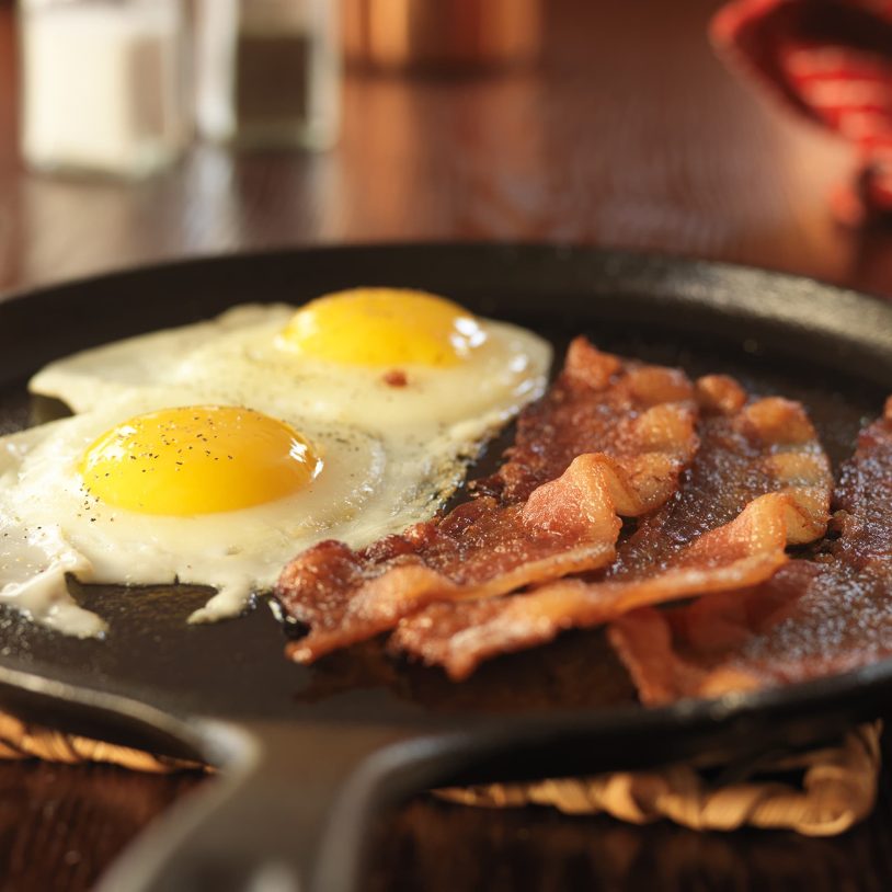 Bacon and over easy eggs on a cast iron skillet