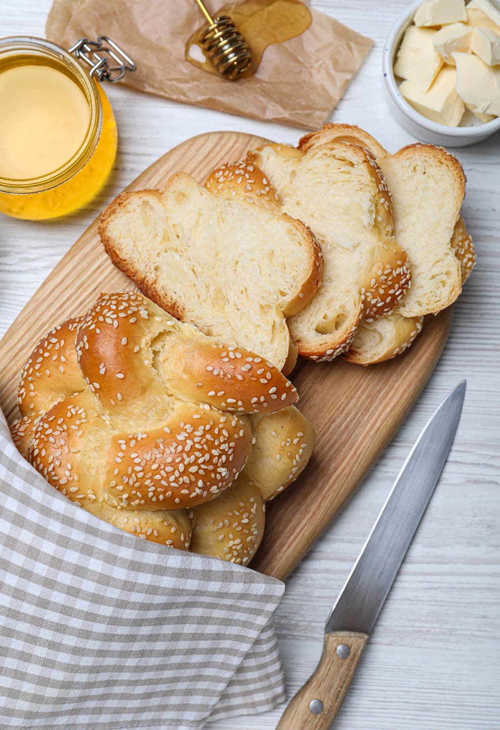 Sliced challah with honey and butter