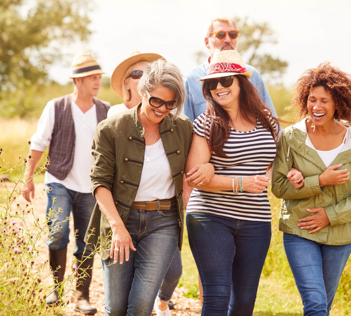 Group of friends walk along a footpath in nature