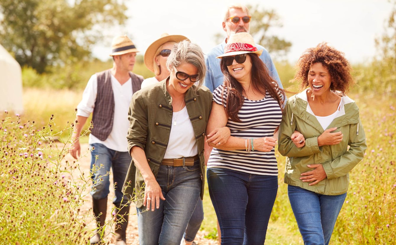 Group of friends walk along a footpath in nature