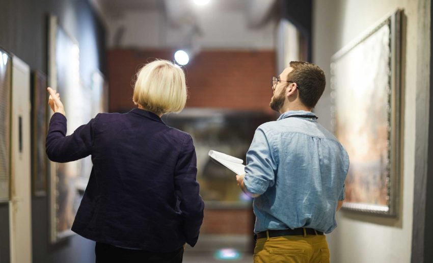 Woman and man looking at artwork