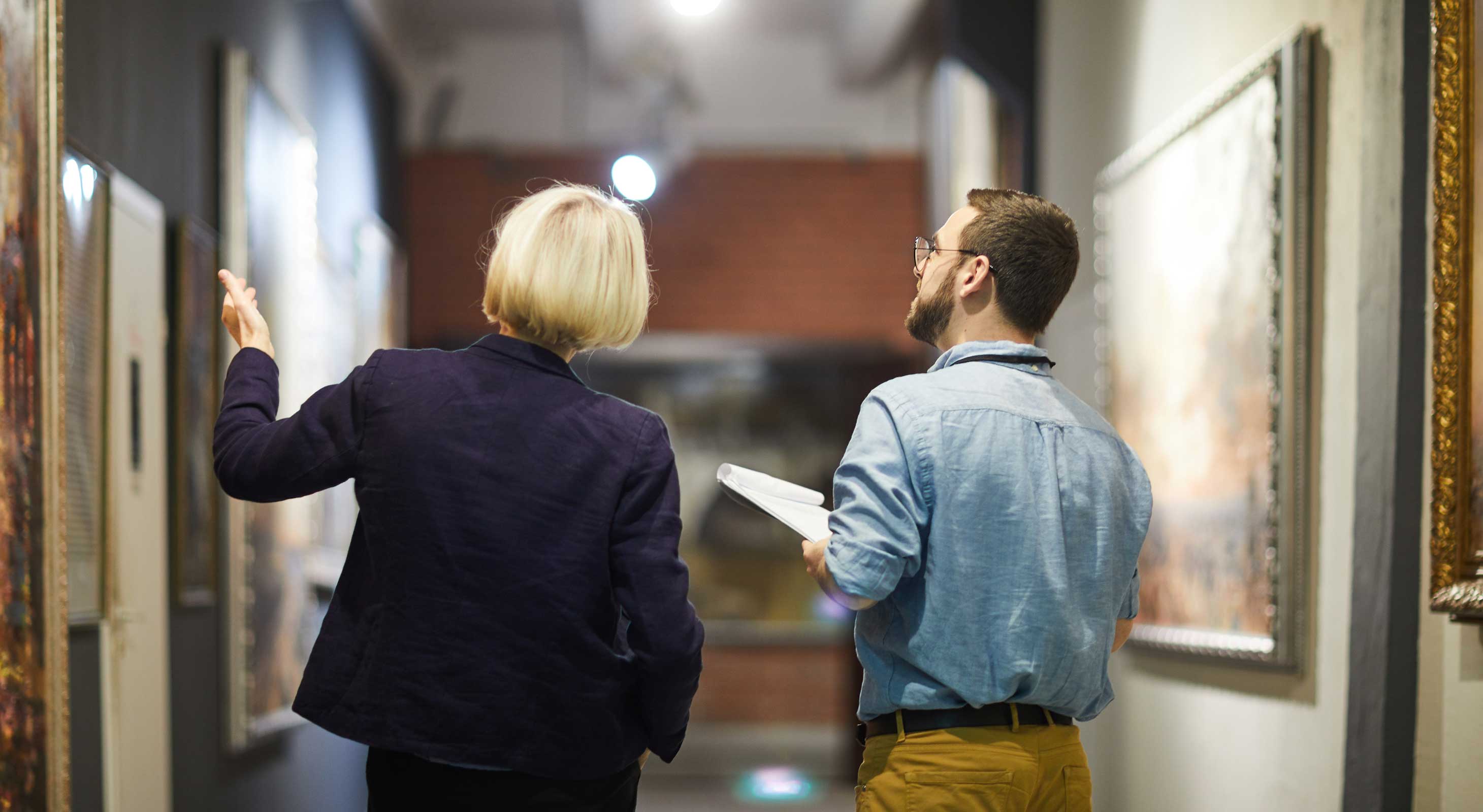 Woman and man looking at artwork