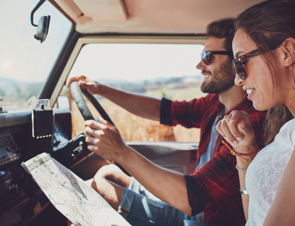 Couple navigating with a map while driving