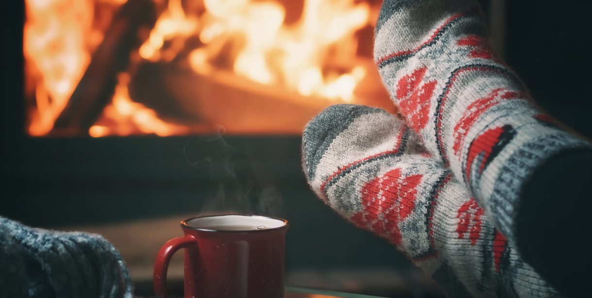 Relaxing by cozy fireplace in winter