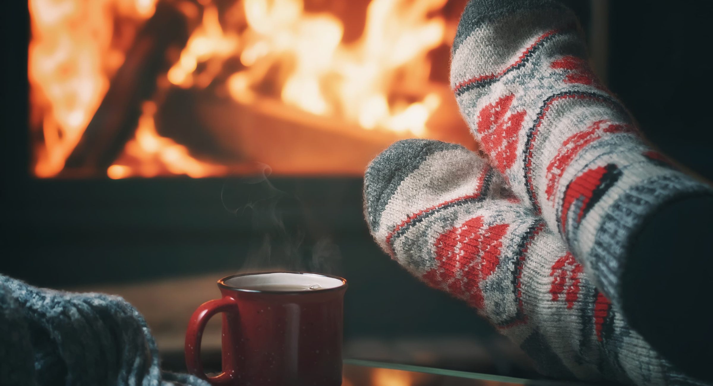 Relaxing by cozy fireplace in winter